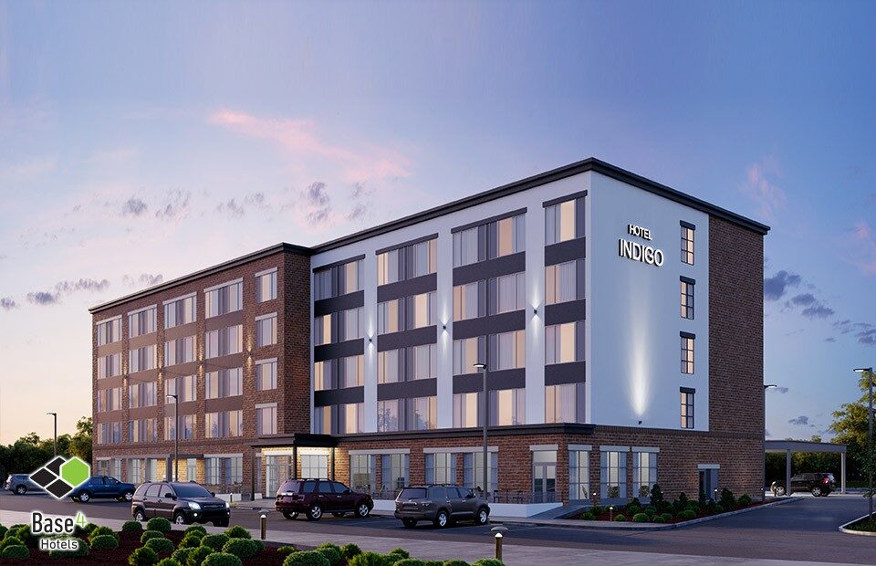 Twilight view of HOTEL INDIGO – HUNTSVILLE, AL showcasing modern architectural design by BASE4 Architects Engineers Designers.