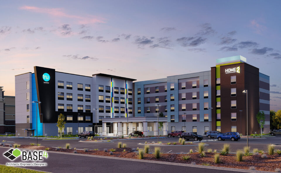 Dual-branded Home2 Suites and Tru by Hilton hotel illuminated at twilight, showcasing modern architecture and branded signage.